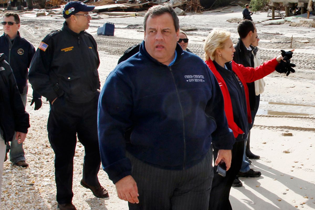 Chris Christie walks past homes devastated by Hurricane Sandy in Mantoloking, N.J., Nov. 2, 2012.                      (AP/Mel Evans)