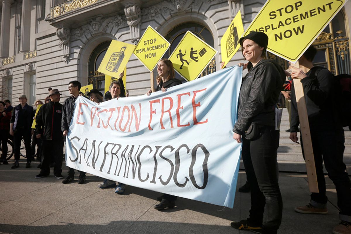 Activists protest outside of City Hall in San Francisco, Jan. 21, 2014. San Francisco officials are set to vote on a plan to start regulating employee shuttles for companies like Google, Facebook and Apple, charging a fee for those that use public bus stops and controlling where they load and unload.                (AP/Jeff Chiu)