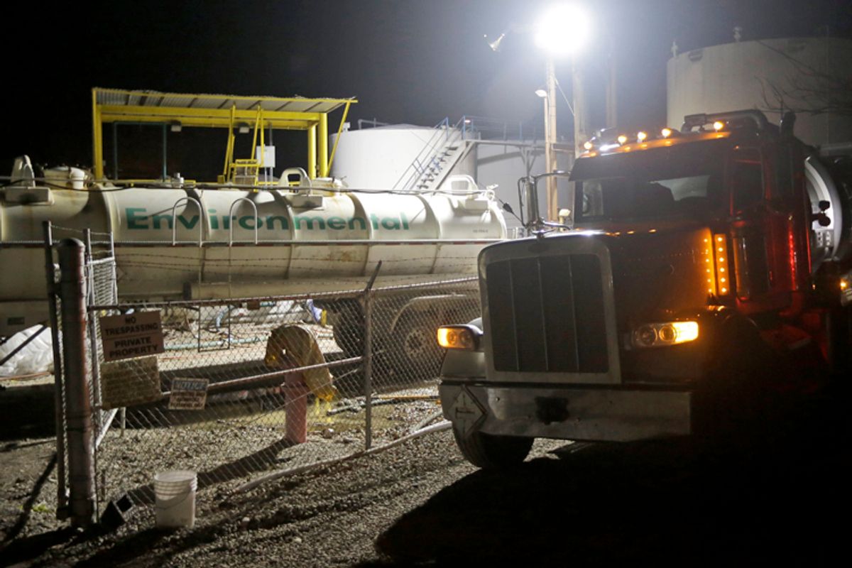 Workers at Freedom Industries work to empty storage tanks of chemicals into tanker trucks, Charleston, Va., Jan. 12, 2014.       (AP/Steve Helber)