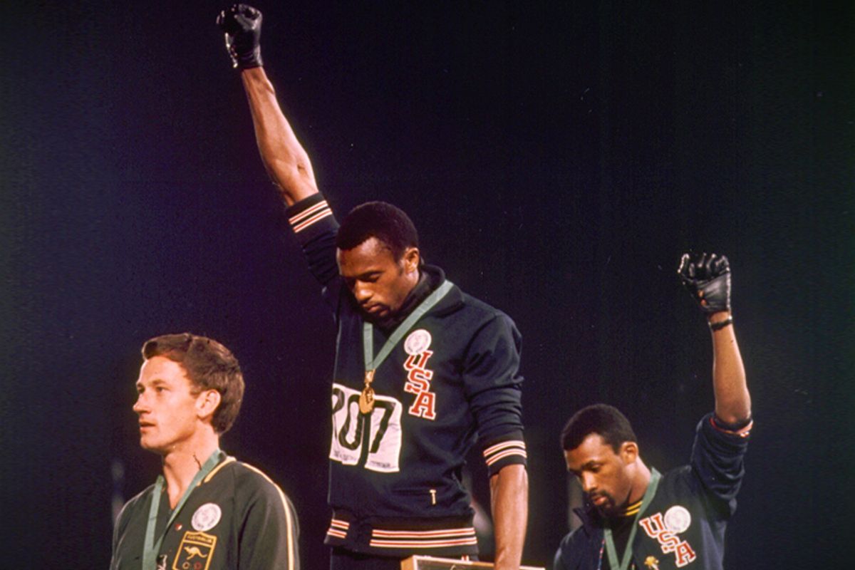 Tommy Smith, center, and John Carlos wear black gloves on upraised right hands during playing of U.S. National Anthem in Mexico City on Oct.16, 1968.      (AP)