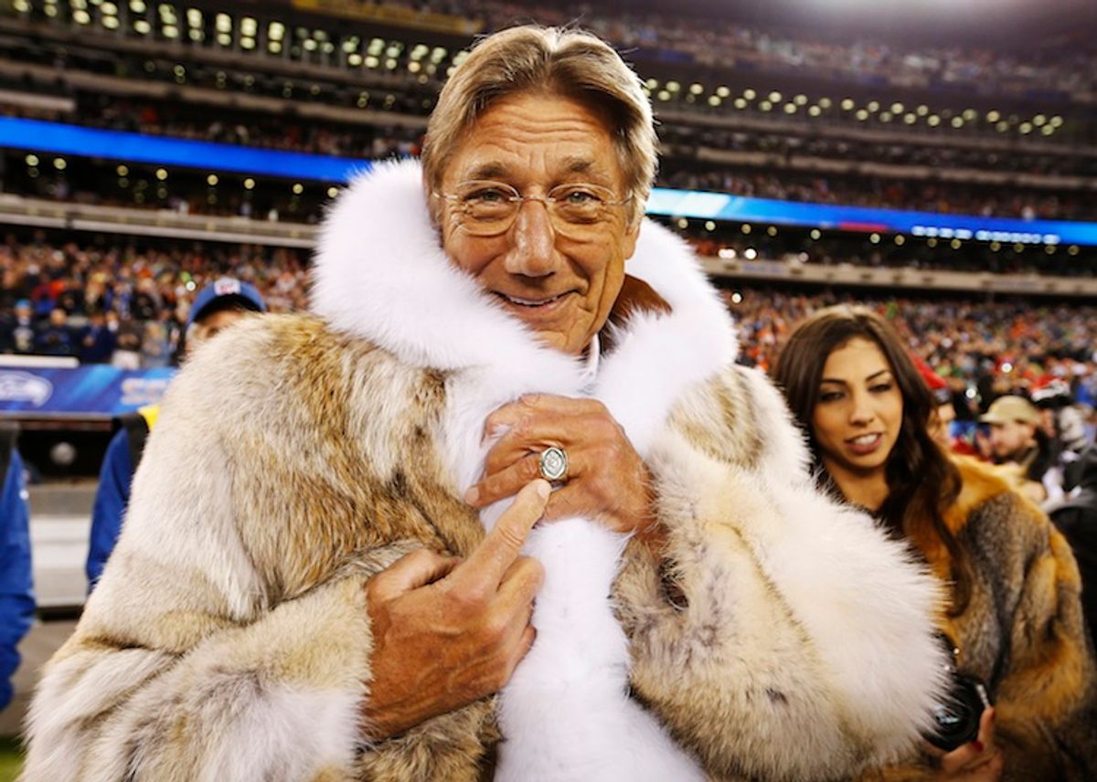 Former New York Jets quarterback Joe Namath points to his championship ring before the Seattle Seahawks play the Denver Broncos in the NFL Super Bowl XLVIII.       (REUTERS/Carlo Allegri)