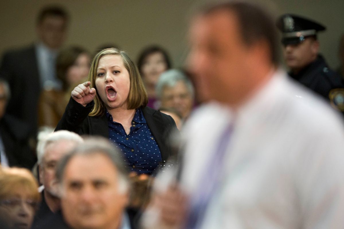 An audience member shouts at New Jersey Gov. Chris Christie at a town hall meeting, March 13, 2014.                             (AP/Matt Rourke)