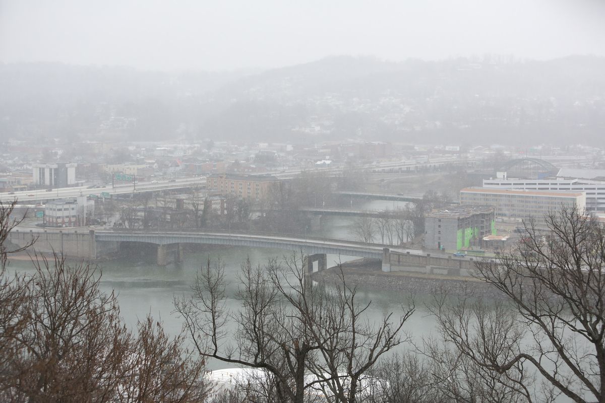 Snow falls over the confluence of the Elk and Kanawha Rivers, Sunday, March 16, 2014, in Charleston, W.Va.    (Marcus Constantino)