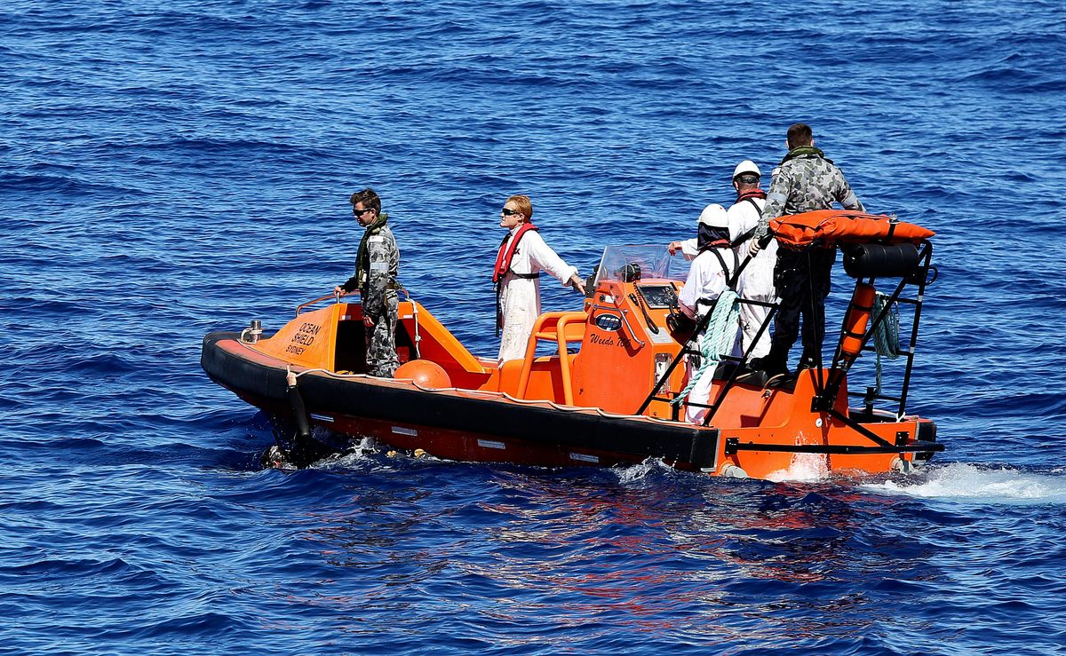 In this April 7, 2014 photo provided by the Australian Defence Force a fast response craft manned by members from the Australian Defence's ship Ocean Shield tows Able Seaman Clearance Diver Michael Arnold as they scan the water for debris of the missing Malaysia Airlines Flight MH370 in the southern Indian Ocean. Up to 14 planes and as many ships were focusing on a single search area covering 77, 580 square kilometers (29,954 square miles) of ocean, 2,270 kilometers (1,400 miles) northwest of the Australian west coast city of Perth, Australia. (AP Photo/ADF, LSIS Bradley Darvill) EDITORIAL USE ONLY    (Lsis Bradley Darvill)