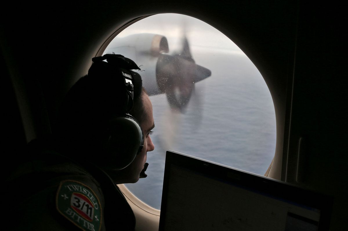 Flight officer Rayan Gharazeddine on board a Royal Australian Air Force AP-3C Orion, searches for the missing Malaysia Airlines Flight MH370 in southern Indian Ocean, Australia, Saturday, March 22, 2014.  A satellite image released by China on Saturday offers the latest sign that wreckage from a Malaysia Airlines plane lost for more than two weeks could be in a remote stretch of the southern Indian Ocean where planes and ships have been searching for three days.  (AP Photo/Rob Griffith, Pool)   (Rob Griffith)