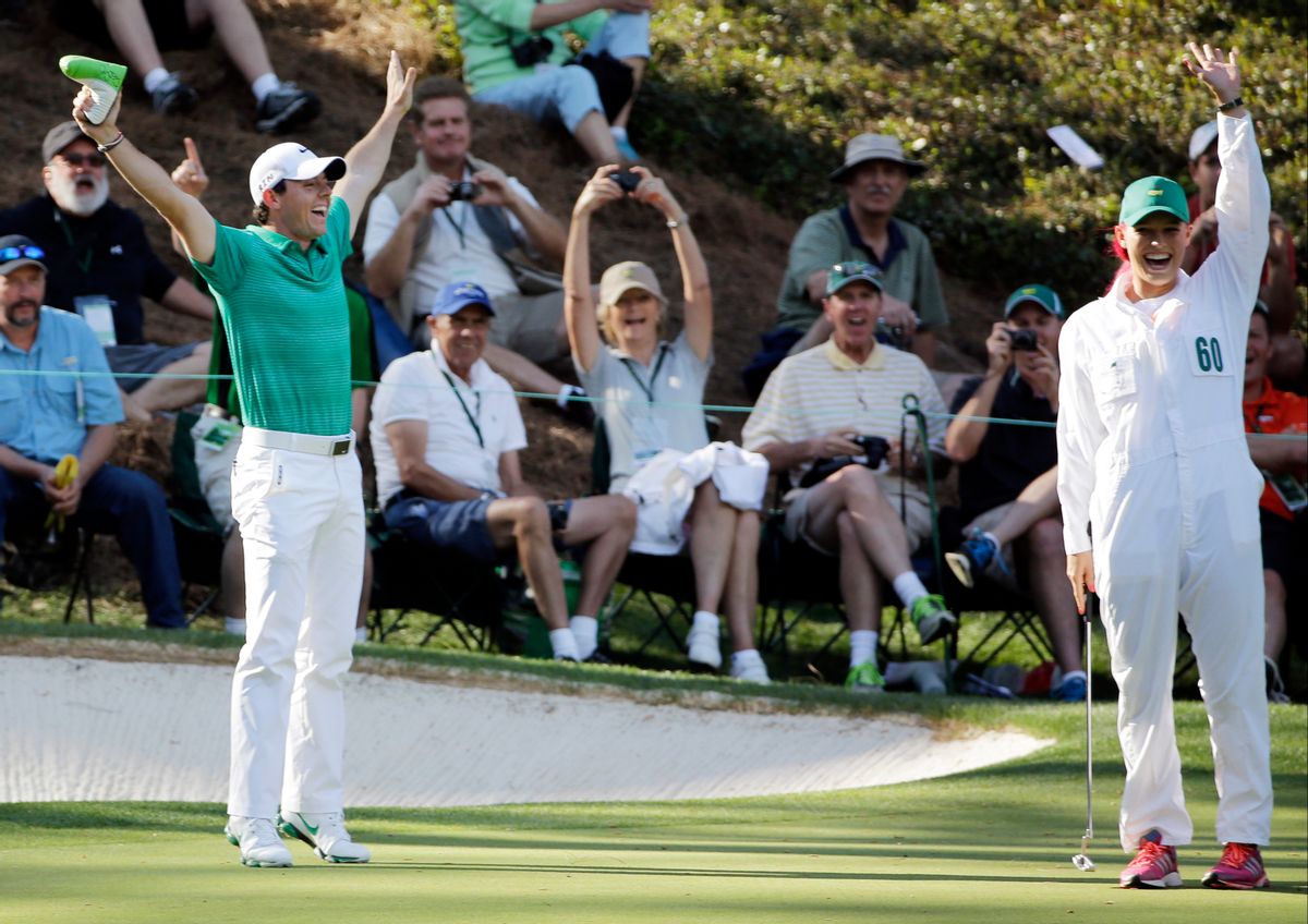 Tennis player Caroline Wozniacki and her fiancee Rory McIlroy, of Northern Ireland, celebrate after Wozniacki putted on the ninth hole during the par three competition at the Masters golf tournament Wednesday, April 9, 2014, in Augusta, Ga. (AP Photo/David J. Phillip) (David J. Phillip)
