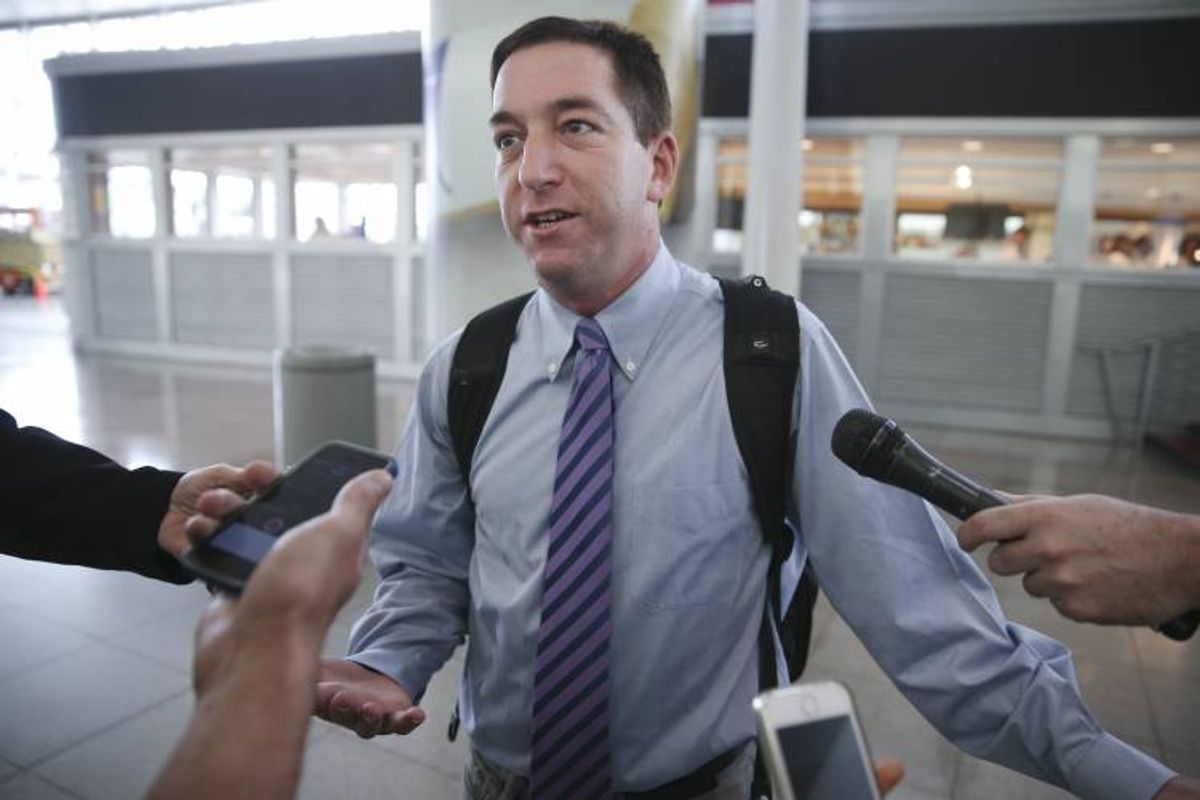 Glenn Greenwald speaks to the media after arriving at John F. Kennedy International Airport, on Friday  (AP)
