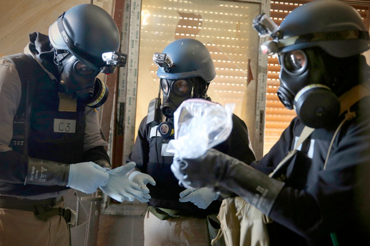 A U.N. chemical weapons expert holds a plastic bag containing samples from one of the sites of an alleged chemical weapons attack in Damascus, August 29, 2013.       (Reuters/Mohamed Abdullah)