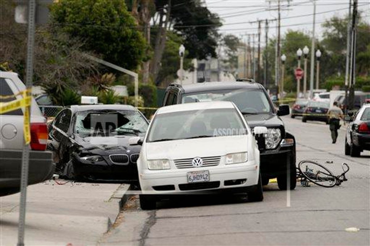 Police tape marks of the scene where a black BMW sedan, left, driven by a drive-by shooter, rests on Saturday, May 24, 2014, in Isla Vista, Calif. The shooter went on a rampage near a Santa Barbara university campus that left seven people dead, including the attacker, and others wounded, authorities said Saturday.      (AP Photo/Jae C. Hong)