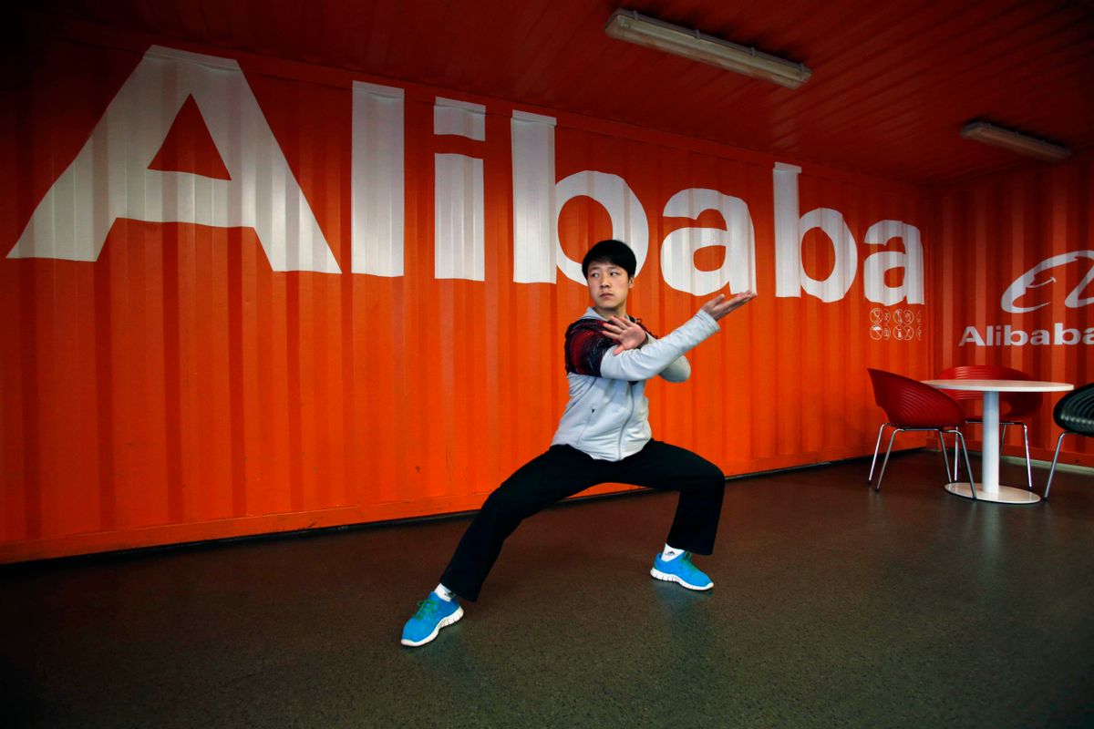 In this file photo taken Tuesday March 26, 2013, a worker performs shadow boxing during an open day at the Alibaba Group office in Hangzhou in east China's Zhejiang province.  (AP Photo)