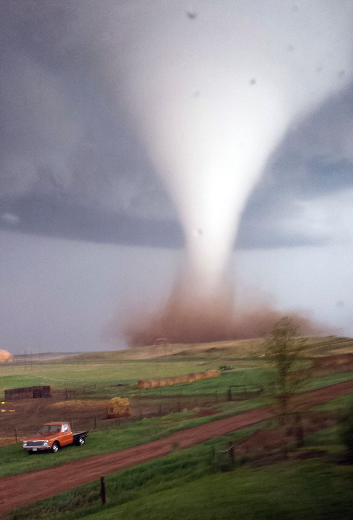 This photo taken on Monday, May 26, 2014 and provided by Jill Helmuth, shows a tornado touching down on a reach before heading towards Watford City, N.D. Authorities say several were injured and more than a dozen trailers were damaged or destroyed Monday evening when the twister tore through a camp where oil field workers stay. (AP Photo/Jill Helmuth) (AP)