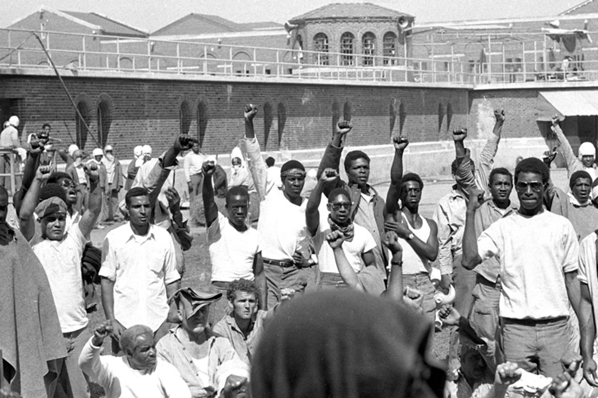 Inmates at Attica State Prison in Attica, N.Y., raise their hands in clenched fists in a show of unity, September 1971, during the Attica uprising.     (AP)