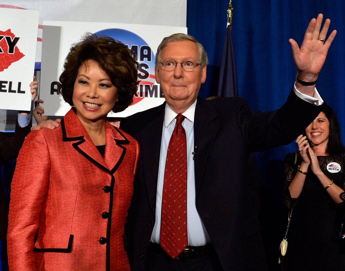Kentucky Senator Mitch McConnell, right, and his wife Elaine Chao wave to his supporters following his victory in the republican primary Tuesday, May 20, 2014, at the Mariott Louisville East in Louisville, Ky. (AP Photo/Timothy D. Easley)  (AP)