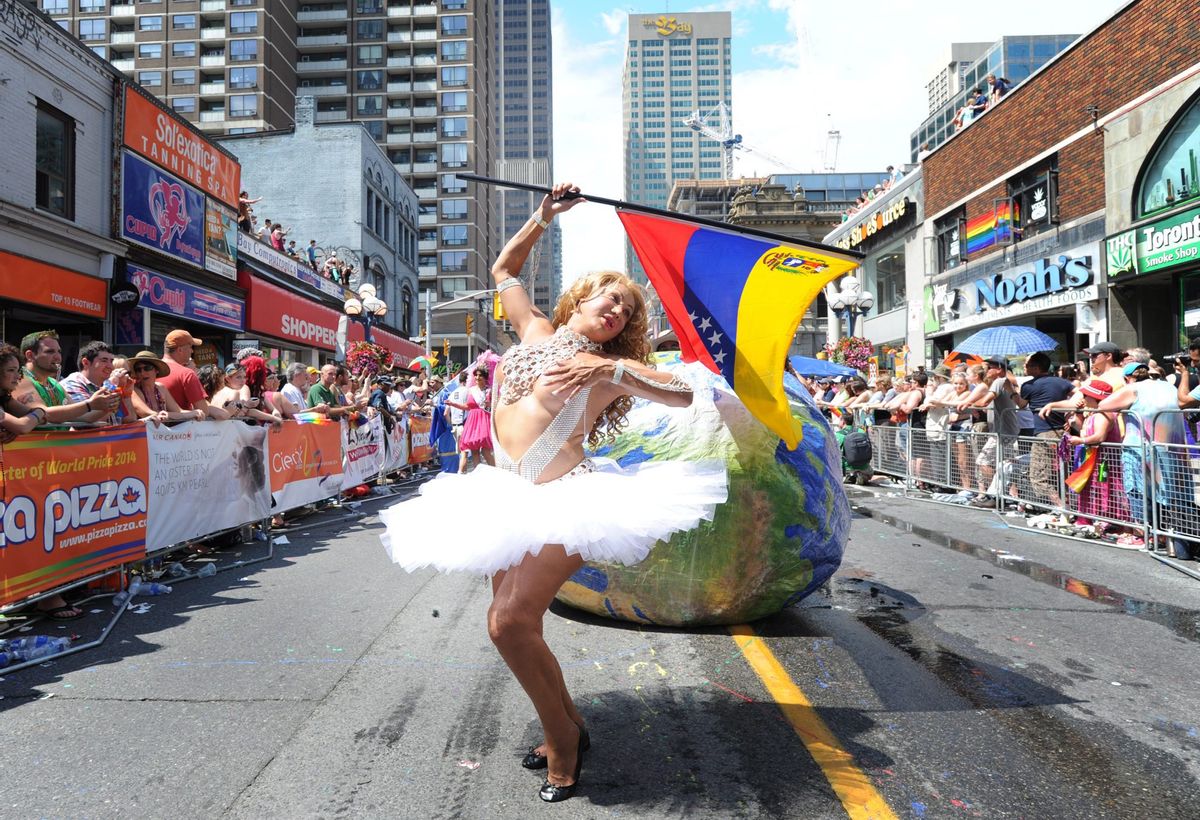 Parade goers celebrate during the WorldPride Parade in Toronto, Sunday, June 29, 2014. The parade, which is the culmination of WorldPride 2014, attracts over a million people. (AP Photo/The Canadian Press, Kevin Van Paassen) (AP)