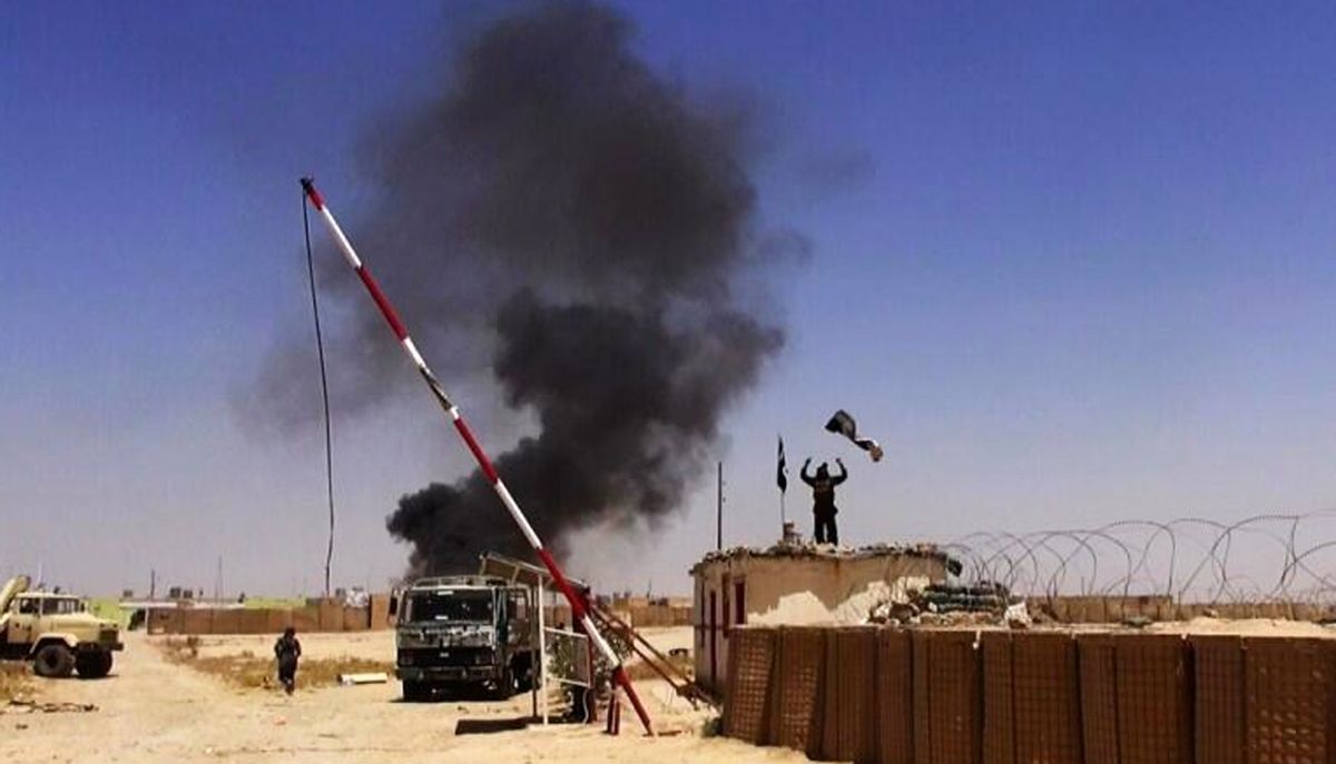 Militants from the al-Qaida-inspired Islamic State of Iraq and the Levant (ISIL) people raising their flag at the entrance of an army base in Ninevah Province. Iraq.  (AP)