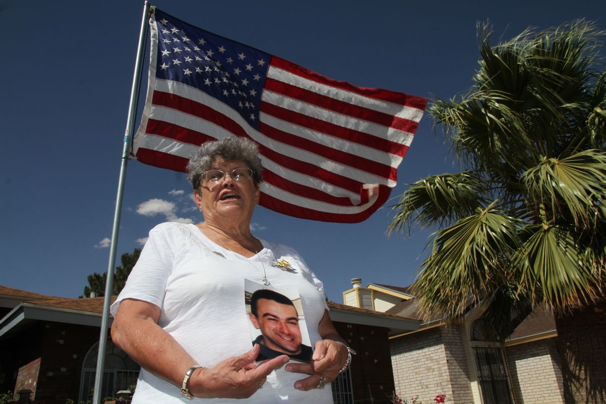 Lillian "Bonnie" D'Amico, poses for a photograph while holding a photo of her son Nicholas D'Amico in El Paso, Texas. Her son killed himself while waiting for a an appointment with a psychiatrist.  (AP)