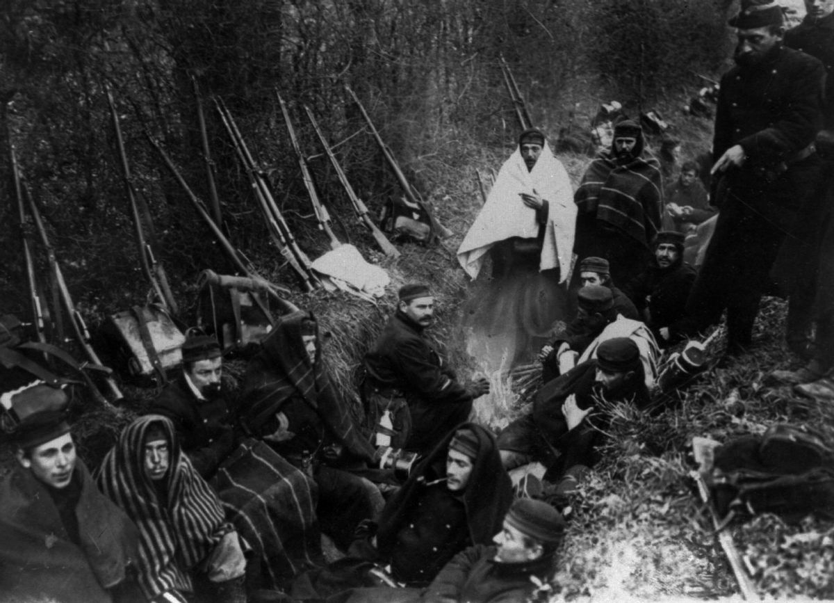 TWENTY ONE OF ONE HUNDRED PHOTOS WORLD WAR ONE CENTENARY TIMELINE - In this 1914 file photo, Allied troops huddle in a trench around a tiny fire near Ypres, Belgium. (AP Photo, File) (AP)
