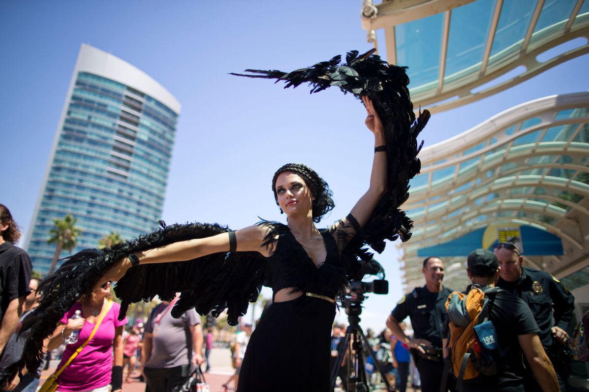 A woman dressed as the character Katniss Everdeen from the movie, "The Hunger Games: Catching Fire," poses in front of Comic-Con Thursday, July 24, 2014, in San Diego. Thousands of fans with four-day passes to the sold-out pop-culture spectacular flocked to the event Thursday, many clad in costumes.  (AP Photo) (AP)