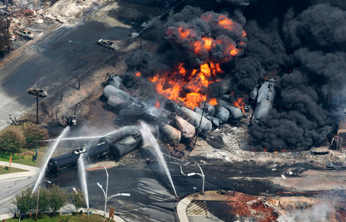 In this Saturday, July 6, 2013 photo, smoke rises from railway cars carrying crude oil after derailing in downtown Lac Megantic, Quebec. (AP Photo/The Canadian Press, Paul Chiasson)  (AP)