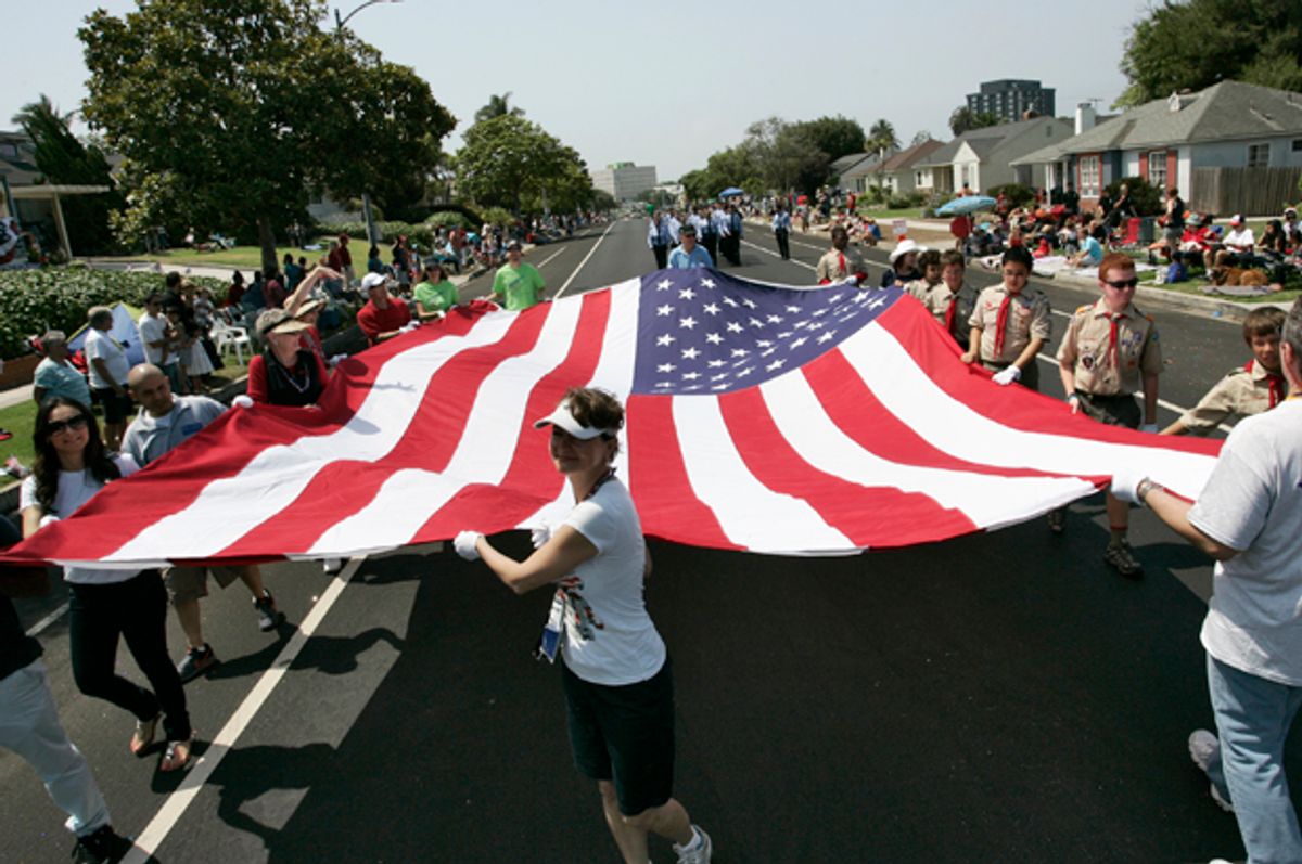 Participants carry a large U.S. flag at a Fourth of July Parade in Los Angeles, California, July 4, 2013.     (Reuters/Jonathan Alcorn)