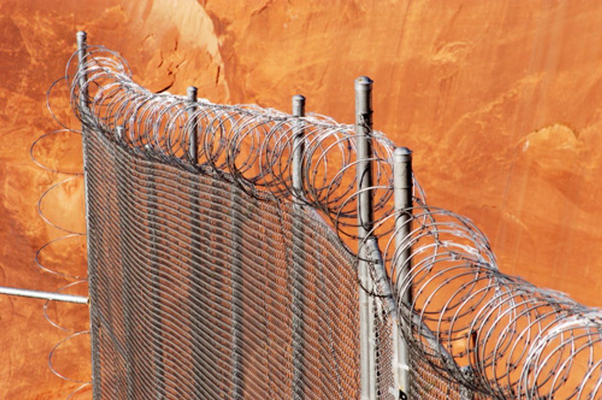 Chain link fence with razor wire.    