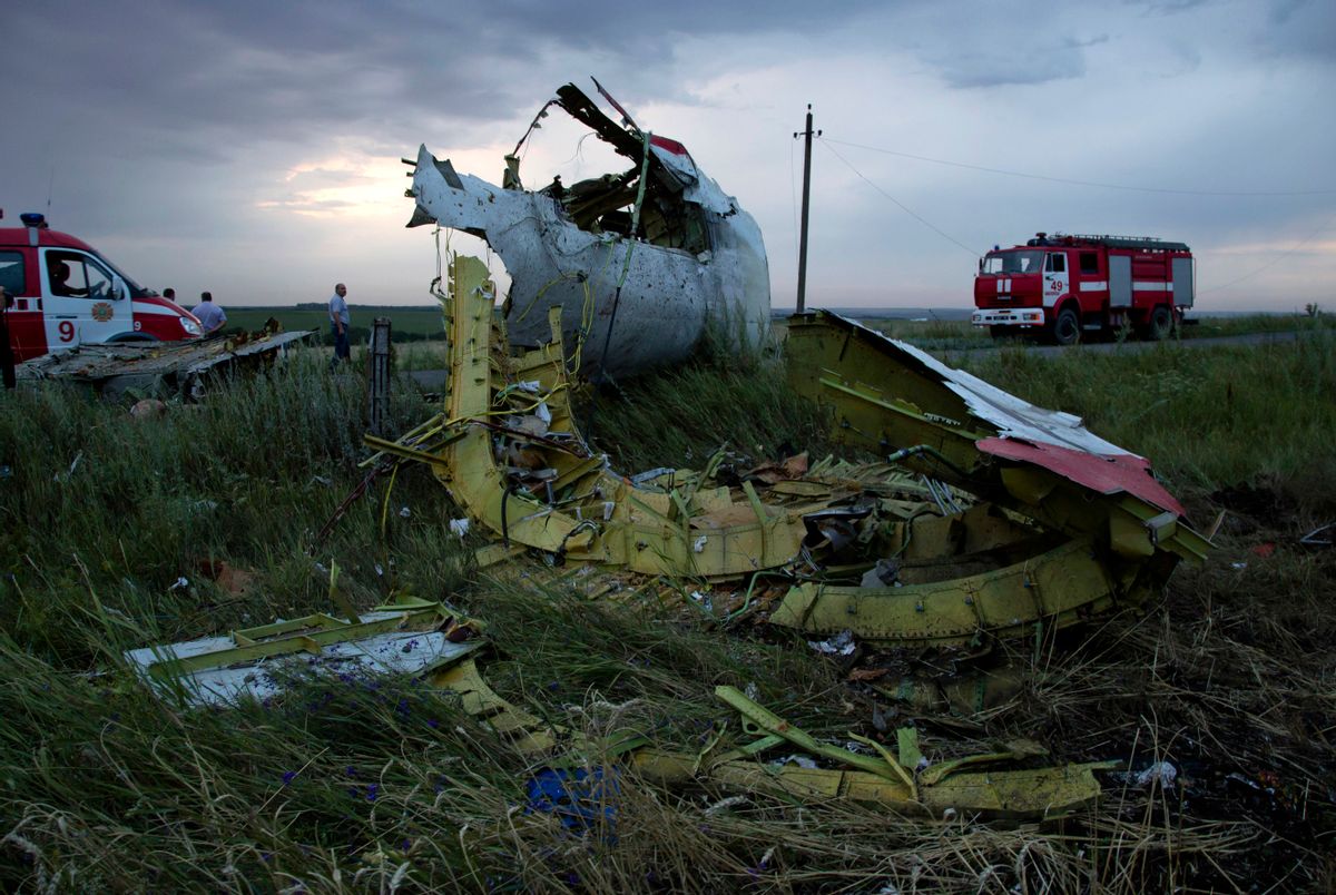 Fire engines arrive at the crash site of a passenger plane near the village of Hrabove, Ukraine, as the sun sets Thursday, July 17, 2014. Ukraine said a passenger plane carrying 295 people was shot down Thursday as it flew over the country, and both the government and the pro-Russia separatists fighting in the region denied any responsibility for downing the plane.   ((AP Photo/Dmitry Lovetsky))