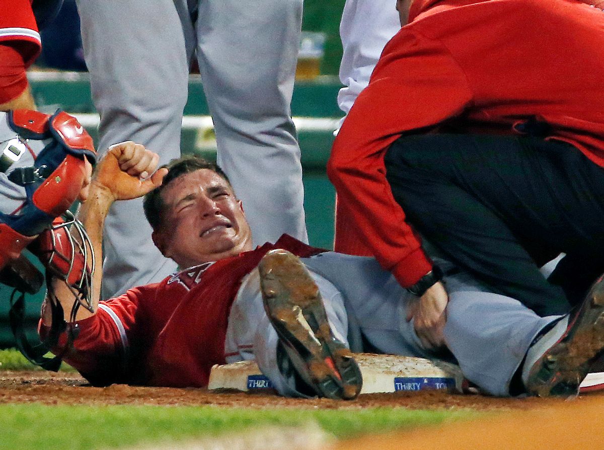 Los Angeles Angels starting pitcher Garrett Richards grimaces as he is attended to on the field after an injury during the second inning of a baseball game against the Boston Red Sox at Fenway Park in Boston, Wednesday, Aug. 20, 2014. (AP Photo/Elise Amendola) (AP)