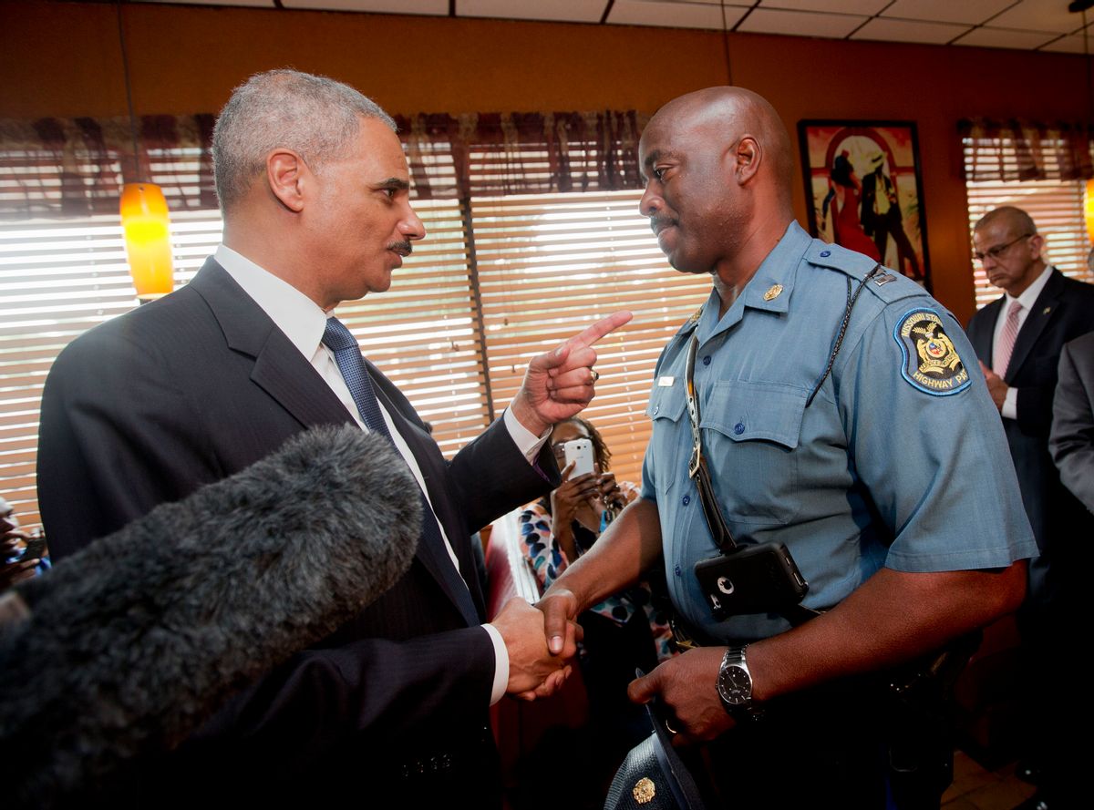 Attorney General Eric Holder talks with Capt. Ron Johnson of the Missouri State Highway Patrol at Drake's Place Restaurant, Wednesday, Aug. 20, 2014, in Florrissant, Mo. Holder arrived in Missouri on Wednesday, as a small group of protesters gathered outside the building where a grand jury could begin hearing evidence to determine whether a Ferguson police officer who shot 18-year-old Michael Brown should be charged in his death. (AP Photo/Pablo Martinez Monsivais, Pool) (AP)