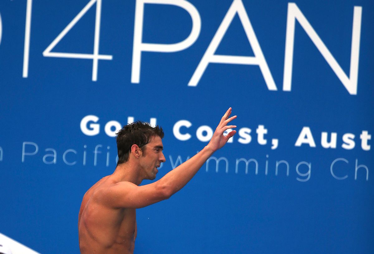 Michael Phelps of the U.S. waves as he leaves the pool deck after his men's 100m freestyle heat at the Pan Pacific swimming championships in Gold Coast, Australia, Friday, Aug. 22, 2014. (AP Photo/Rick Rycroft) (Rick Rycroft)