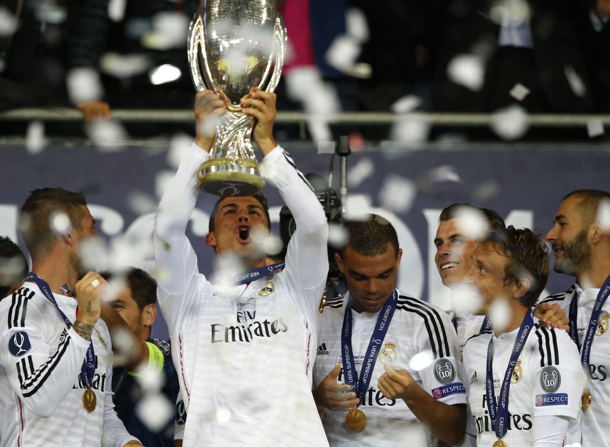 Real Madrids Cristiano Ronaldo lifts the trophy after winning the UEFA Super Cup soccer match between Real Madrid and Sevilla in Cardiff City Stadium, in Cardiff, Wales, Tuesday, Aug. 12, 2014. (AP Photo/Alastair Grant) (AP)