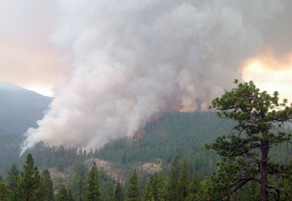 This Monday, July 28, 2014 photo released Thursday, July 31, 2014 by the U.S. Forest Service, shows flames and smoke in the Sierra National Forest, Calif. (AP Photo/U.S. National Forest Service, Burt Stalter)  