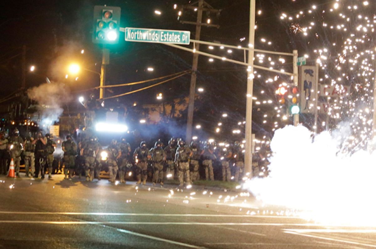 A device deployed by police goes off in the street as police and protesters clash Wednesday, Aug. 13, 2014, in Ferguson, Mo.                    (AP/Jeff Roberson)