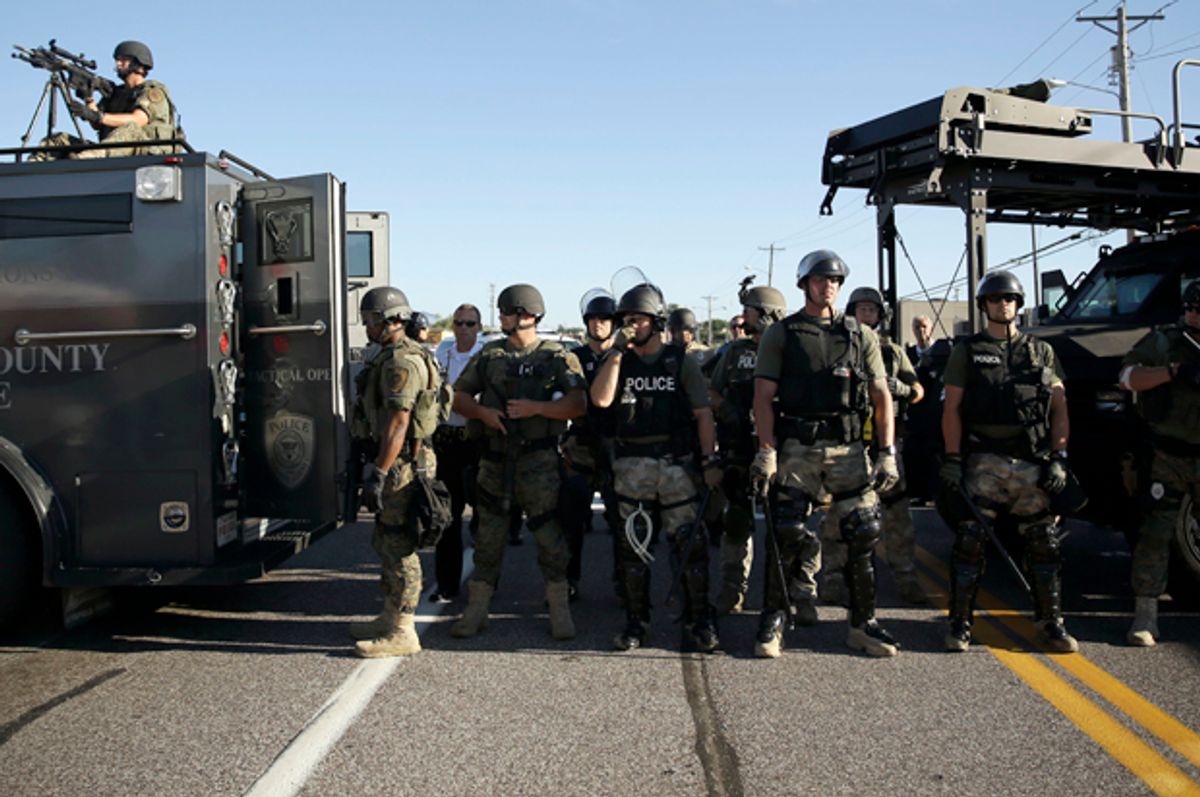 Police in riot gear watch protesters in Ferguson, Mo., Aug. 13, 2014.                  (AP/Jeff Roberson)