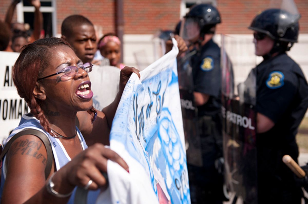 Marcelle Stewart confronts police officers during a march and rally in downtown Ferguson, Mo., Aug. 11, 2014.                         (AP/Sid Hastings)