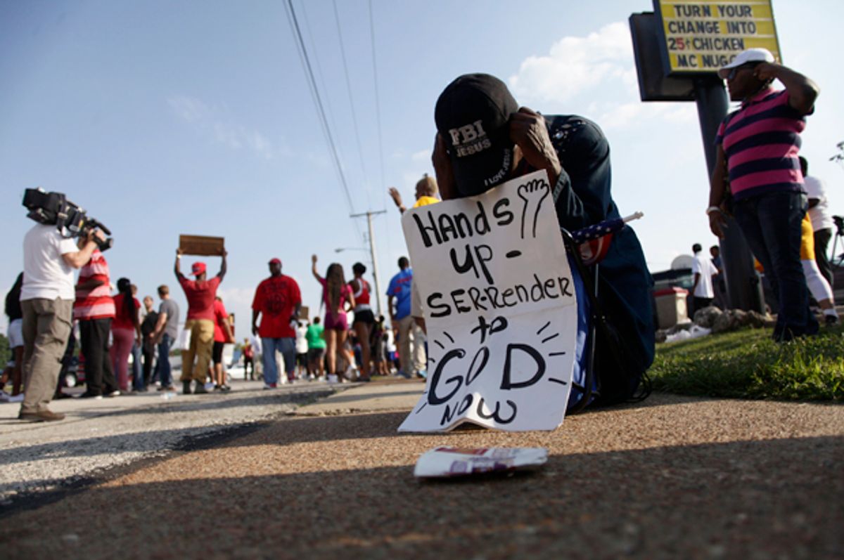 A demonstrator kneels and prays during a protest against the shooting death of Michael Brown in Ferguson, Missouri August 18, 2014.          (Reuters/Joshua Lott)
