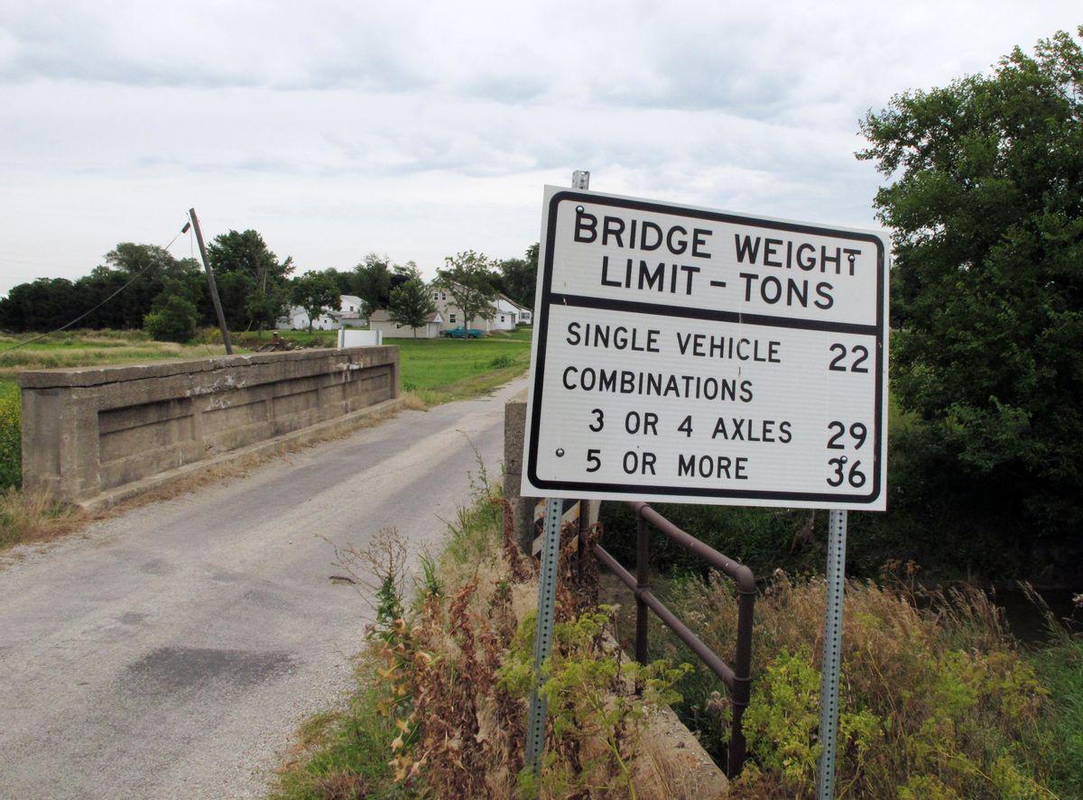 In this July 25, 2014 photo, the owner of Stockland Grain Co. in Stockland, Ill., says this small bridge just west of town is widely used by farmers trying to reach the company's elevator. But the little bridge won't handle fully loaded trucks, forcing farmers to make extra trips and spend extra money. The trade groups that represent soybean farmers say bridges like this all across the country need improvement and they're hoping a campaign to focus attention on this critical piece of the transportation infrastructure they rely on will pay off with better bridges and a better understanding among government decision-makers of their importance to farmers. (AP Photo/David Mercer) (AP)