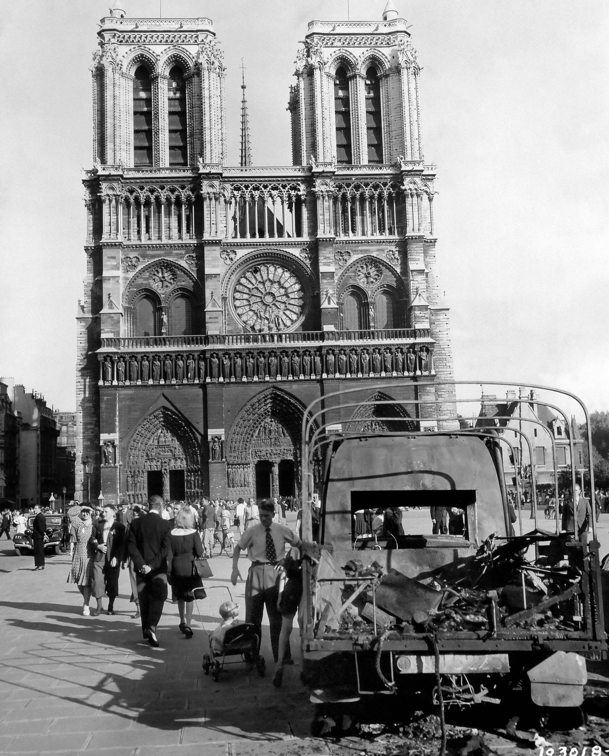 In this image provided by the U.S. Army Signal Corps, French tricolors fly from the twin towers of the famous Notre Dame Cathedral in Paris on August 31, 1944, as Parisians visit the church, which escaped serious damaged during the fighting for the liberation of the French capital. Burned-out German truck in foreground is only sign of war in the vicinity. (AP Photo/U.S. Army Signal Corps) (AP)