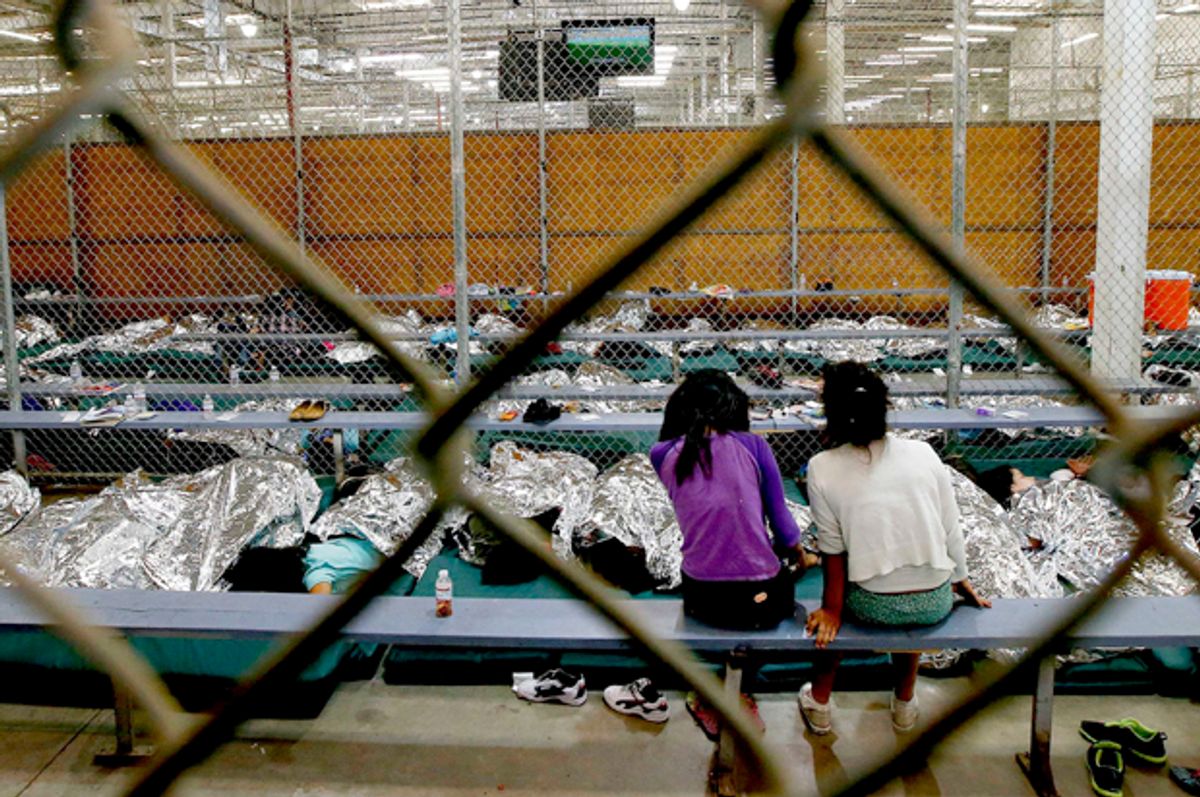 Two young girls at the U.S. Customs and Border Protection Nogales Placement Center in Nogales, Arizona, June 18, 2014.         (Reuters/Ross D. Franklin)
