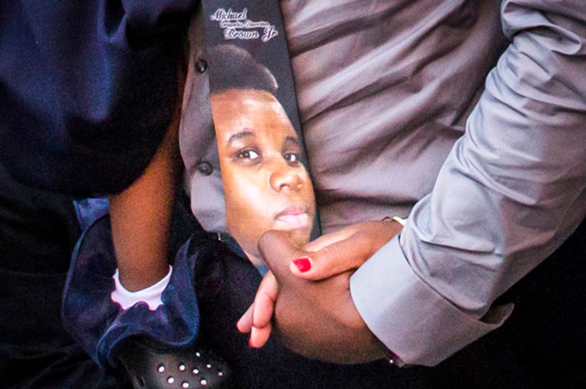 An image of Michael Brown is seen on a tie worn by his father, at the Friendly Temple Missionary Baptist Church in St. Louis, Missouri, August 25, 2014.                    (Reuters/Adrees Latif)