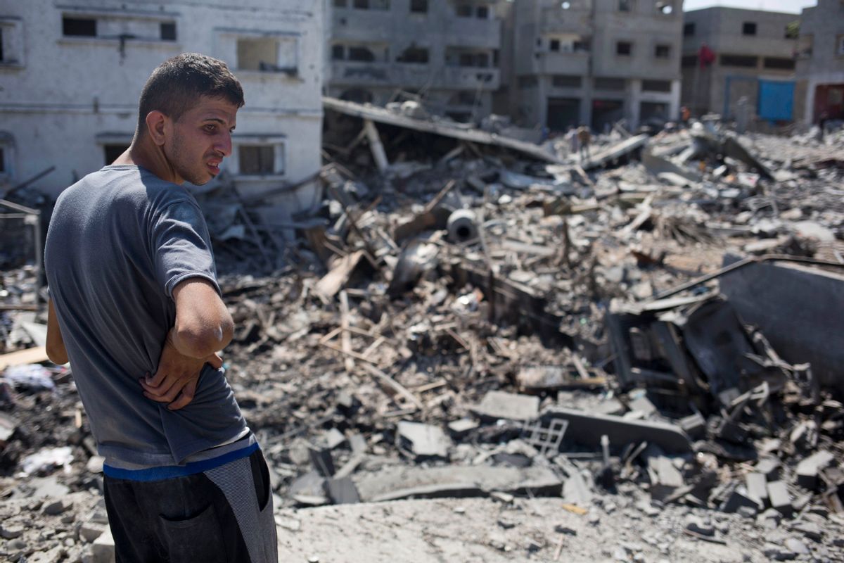 A Palestinian inspects a destroyed house in the heavily bombed Gaza City neighborhood of Shijaiyah, close to the Israeli border, Friday, Aug. 1, 2014. A three-day Gaza cease-fire that began Friday quickly unraveled, with Israel and Hamas accusing each other of violating the truce as several Palestinians were killed in a heavy exchange of fire in the southern town of Rafah. (AP Photo/Dusan Vranic) (AP)