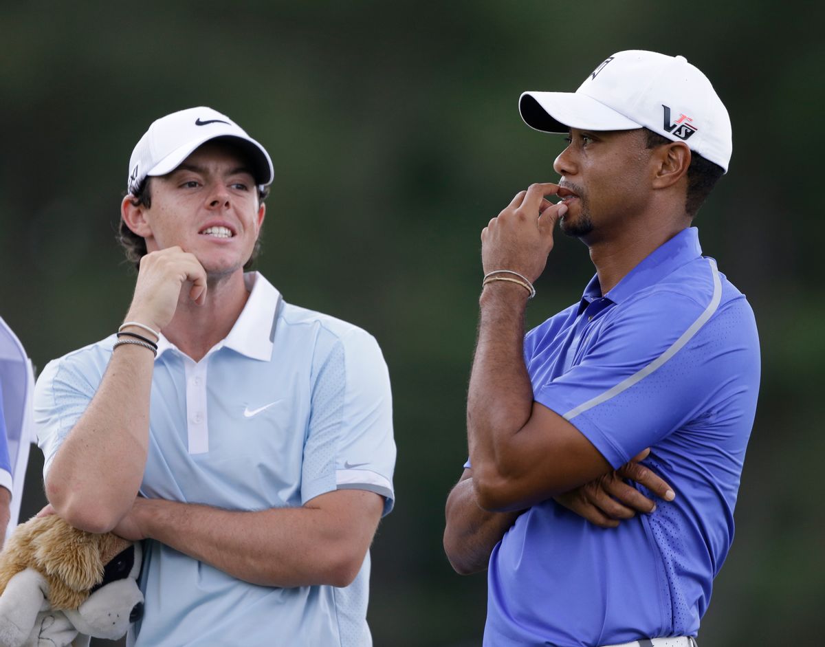 FILE - In this June 13, 2013, file photo, Rory McIlroy, left, and Tiger Woods stand together during the first round of the U.S. Open golf tournament at Merion Golf Club in Ardmore, Pa. Anyone could see McIlroy had the gifts to be the next big thing in golf. His victory in the PGA Championship was more about grit. And now the comparisons with Woods are becoming inevitable. (AP Photo/Darron Cummings, File) (AP)