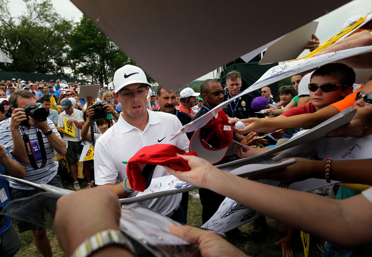 Rory McIlroy, of Northern Ireland, signs autographs after a practice round for the PGA Championship golf tournament at Valhalla Golf Club on Tuesday, Aug. 5, 2014, in Louisville, Ky. The tournament is set to begin on Thursday. (AP Photo/David J. Phillip) (David J. Phillip)