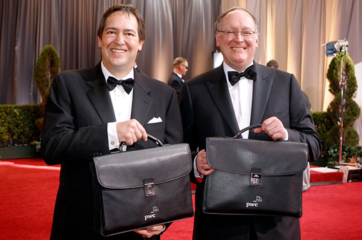 The results of the Academy Awards balloting are carried up the red carpet by Price Waterhouse Coopers accountants Rick Rosas and Brad Oltmans, February 26, 2012.        (Reuters/Lucas Jackson)