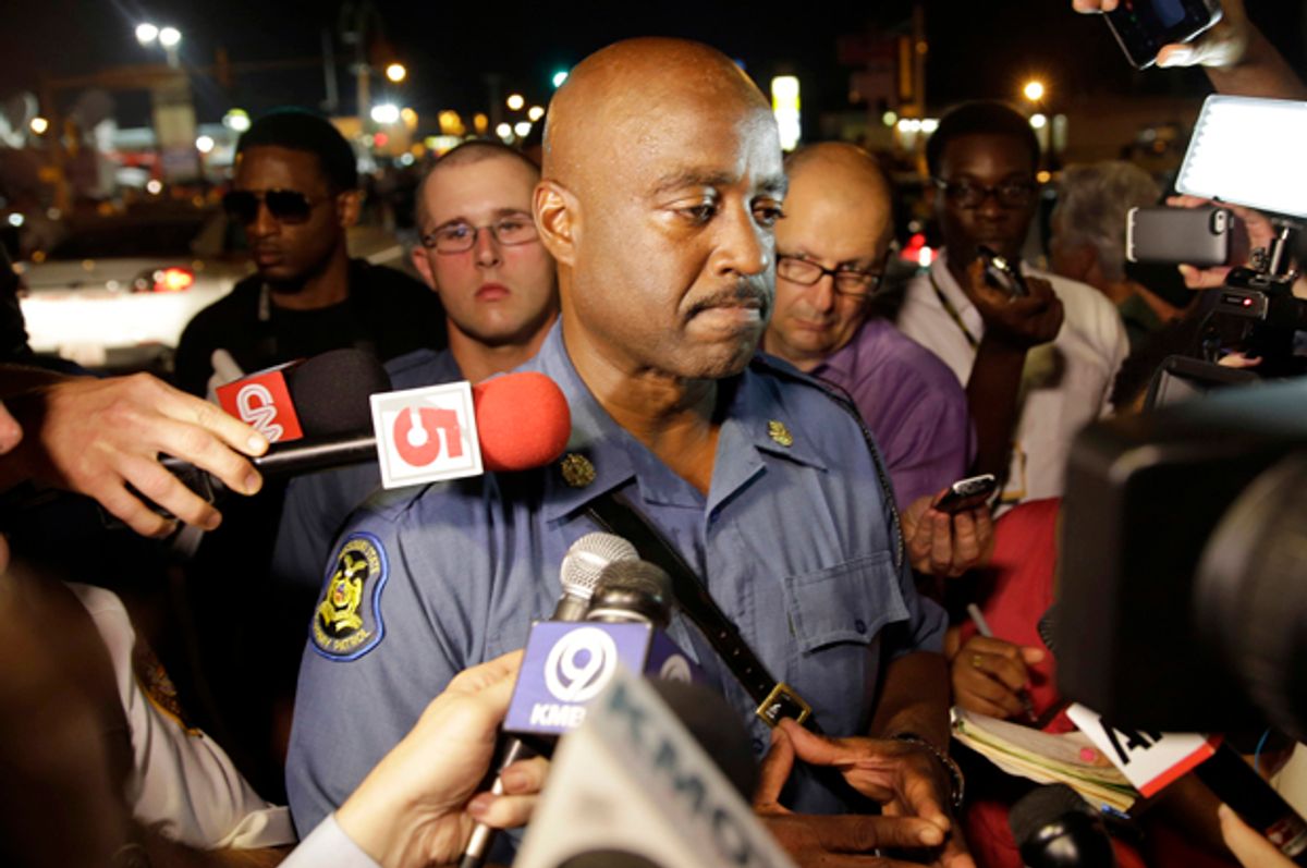 Capt. Ron Johnson of the Missouri Highway Patrol is surrounded by media after meeting with protesters Monday, Aug. 18, 2014, in Ferguson, Mo.            (AP/Jeff Roberson)