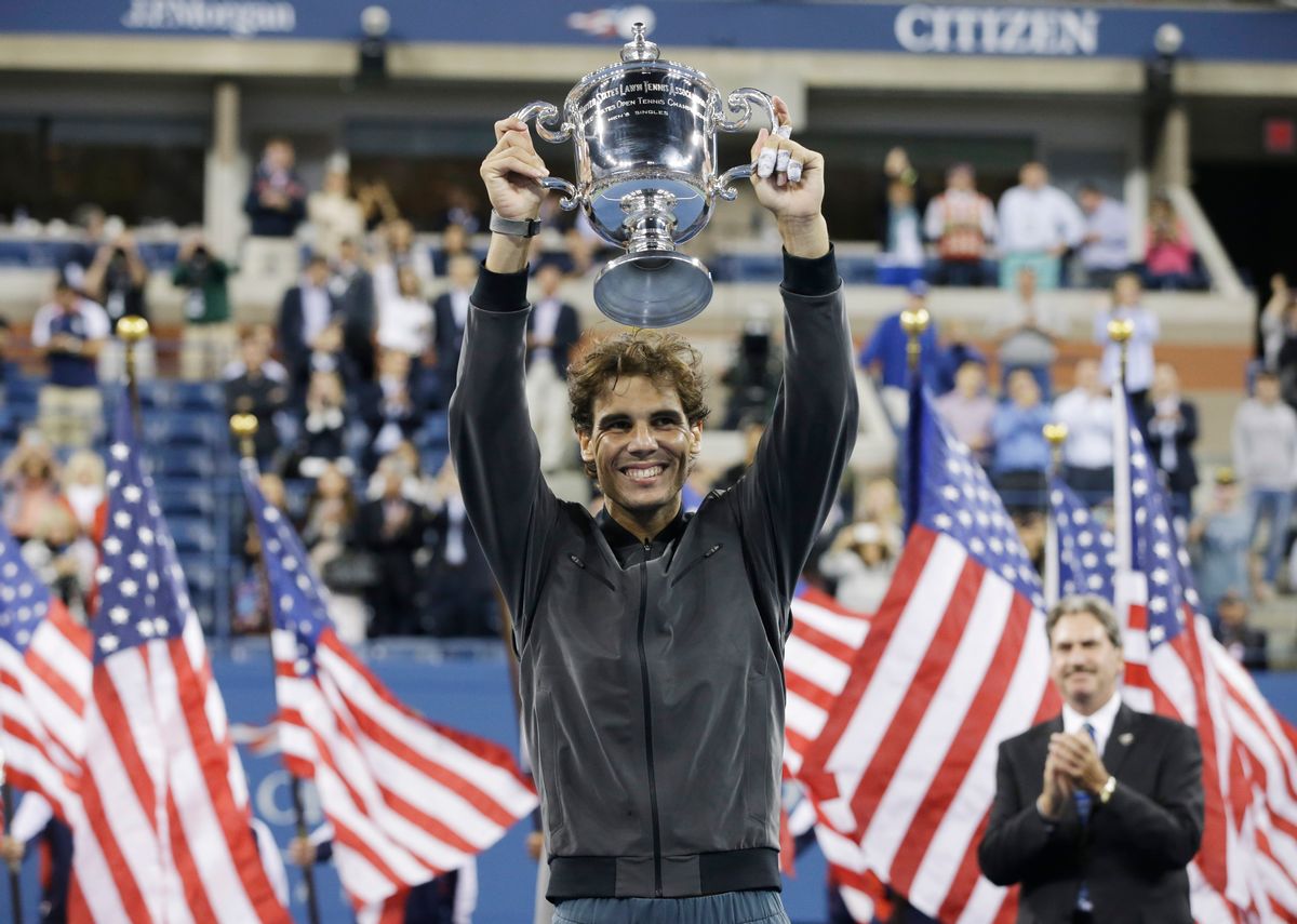 FILE - In this Sept. 9, 2013, file photo, Rafael Nadal, of Spain, holds up the championship trophy after winning the men's singles final over Novak Djokovic, of Serbia, at the 2013 U.S. Open tennis tournament in New York. Nadal will not defend his title at the U.S. Open because of an injured right wrist. Nadal and the tournament announced his withdrawal Monday, Aug. 18, 2014, a week before the year's last Grand Slam tournament begins. (AP Photo/Darron Cummings, File) (AP)