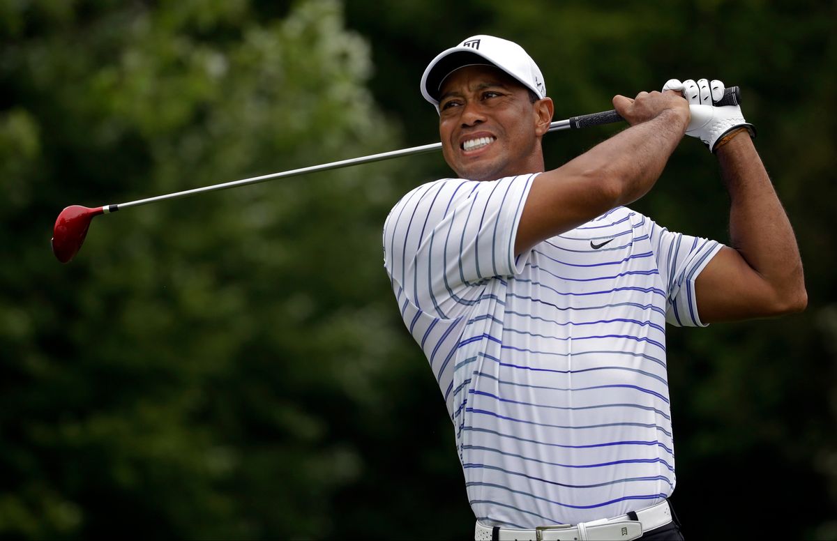 Tiger Woods winces after tee shot on the sixth hole during the second round of the PGA Championship golf tournament at Valhalla Golf Club on Friday, Aug. 8, 2014, in Louisville, Ky. (AP Photo/Jeff Roberson) (Jeff Roberson)