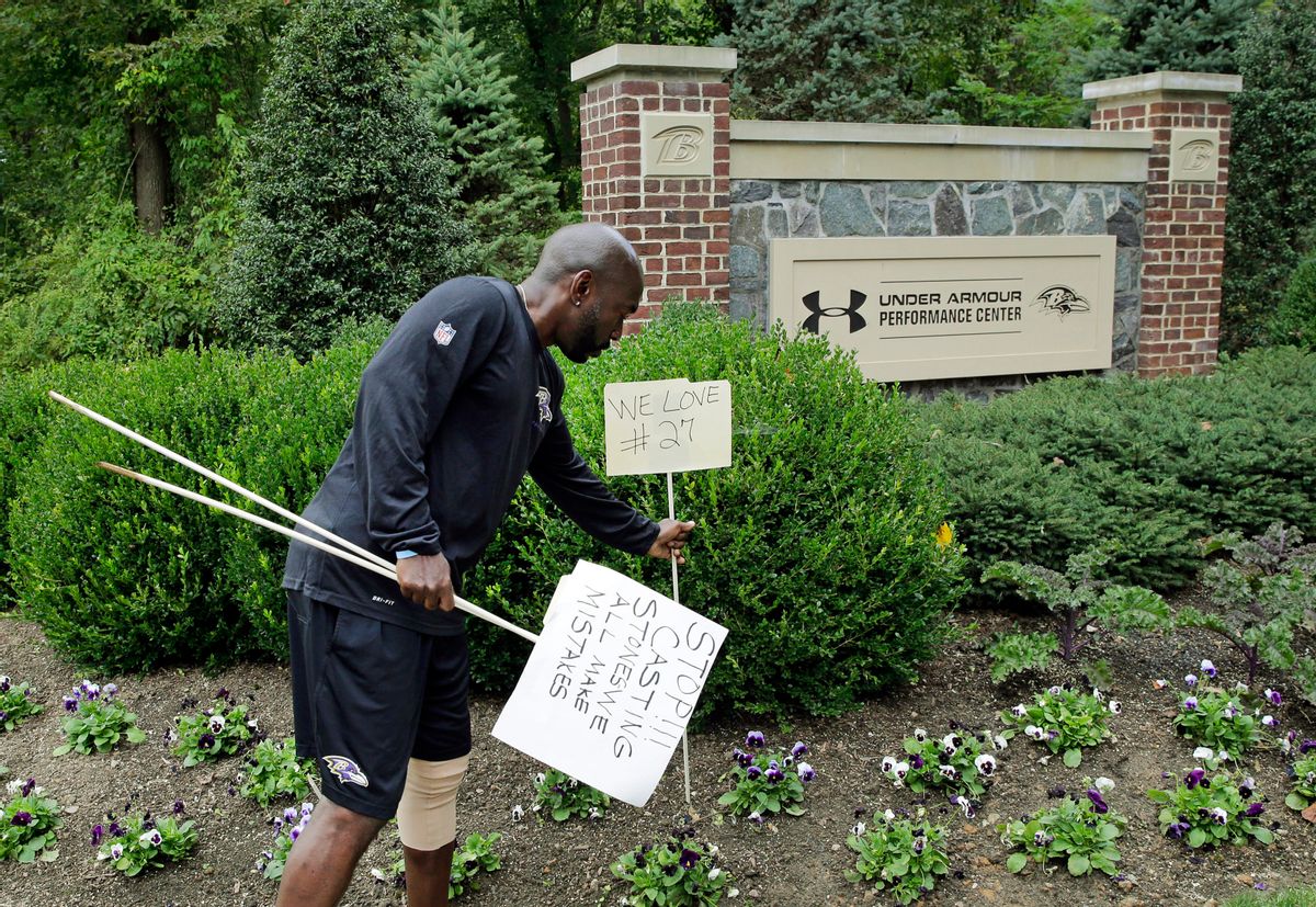Baltimore Ravens senior director of security Darren Sanders removes signs that were posted in support of former Ravens running back Ray Rice in front of the NFL team's headquarters, Monday, Sept. 8, 2014, in Owings Mills, Md. Rice was let go by the Ravens on Monday and suspended indefinitely by the NFL after a video was released showing the running back striking his then-fiancee in February. (AP Photo/Patrick Semansky) (AP)