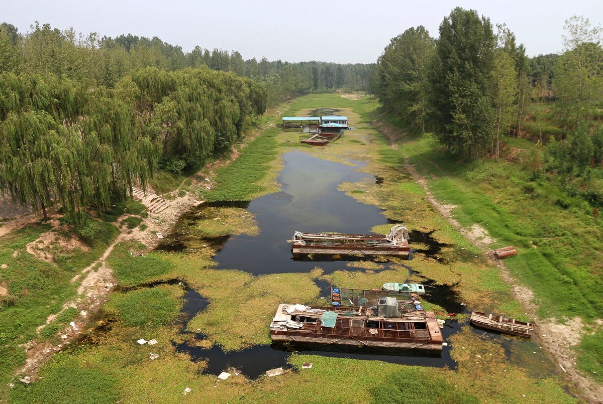 In this Monday, July 28, 2014 photo, boats sit on a dried river bed in Xunxian county in central China's Henan province. After a season of record-breaking drought across China, groundwater levels have hit historic lows this year in northeast and central parts of China where hundreds of millions of people live. Reservoirs grew so dry in agricultural Henan province that the city of Pingdingshan closed car washes and bathhouses and extracted water from puddles. (AP Photo) CHINA OUT (AP)