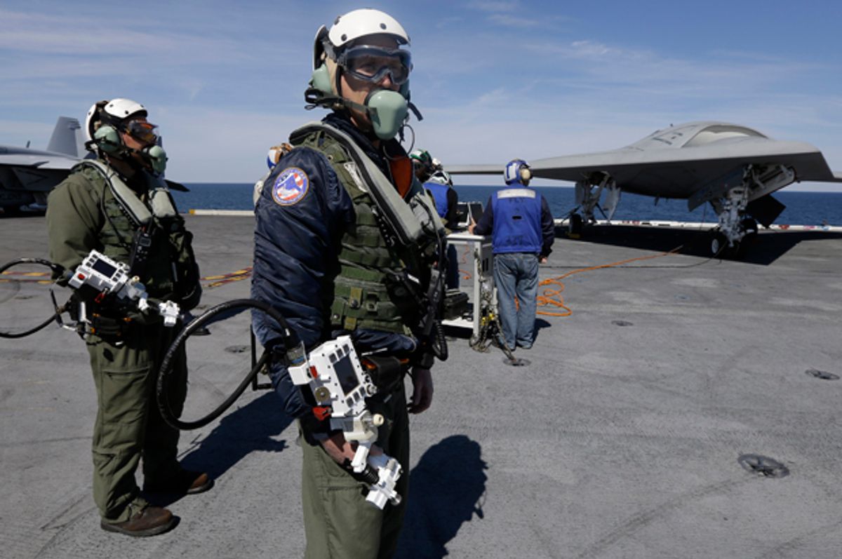 Northrop Grumman test pilots prepare to taxi the Navy X-47B drone, to be launched off the USS George H. W. Bush.    (AP/Steve Helber)