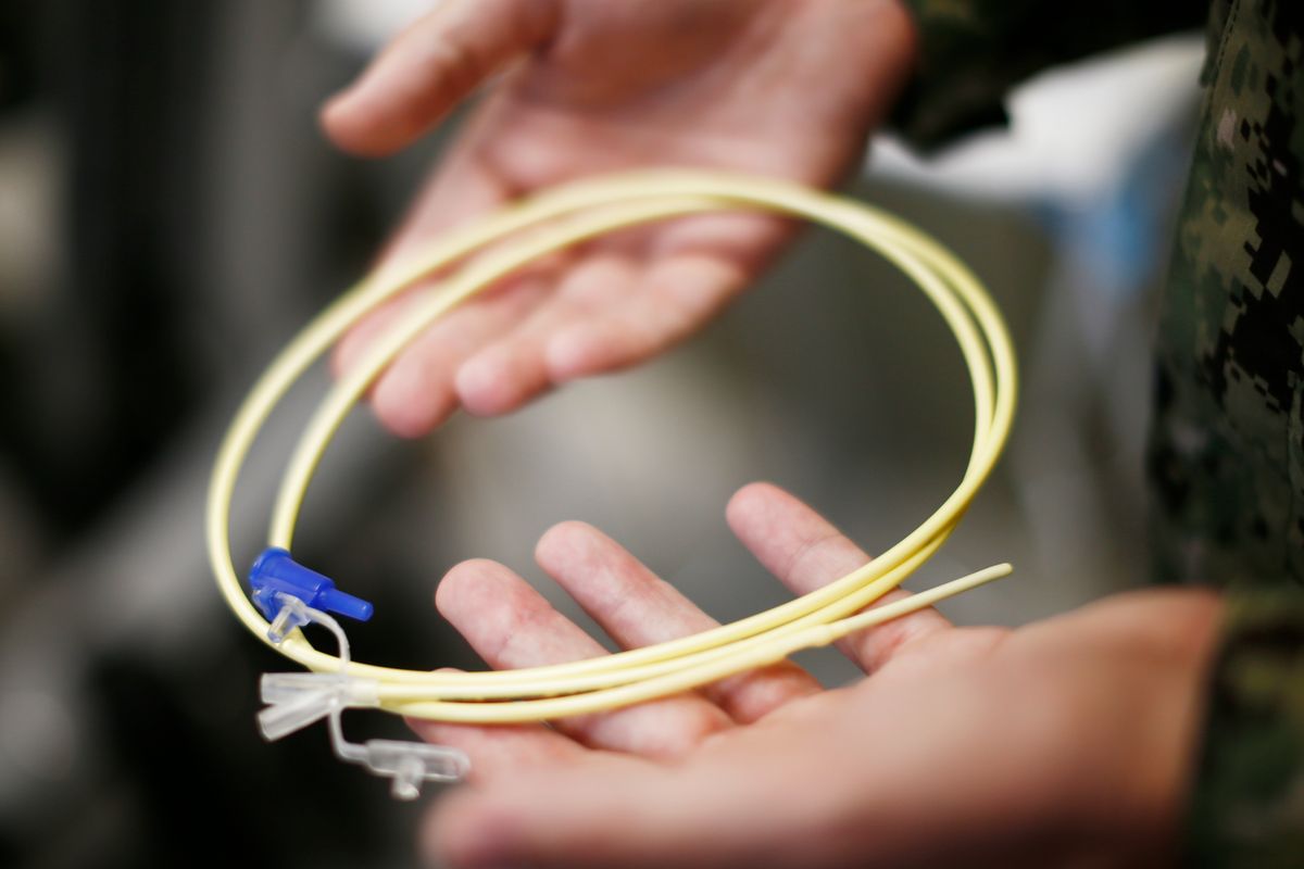 In this Nov. 20, 2013, file photo, reviewed by the U.S. military, U.S. Navy medical personnel displays an enteral feeding tube, used for force-feeding detainees, during a tour of the detainee hospital at Guantanamo Bay Naval Base, Cuba. Guantanamo prisoner, 43-year-old Abu Wael Dhiab has been engaged in a tense struggle with guards in recent months during 2014, according to documents filed in federal court in Washington, where Dhiab, who has been fed by through a nasal tube to prevent starvation, is challenging some of the tactics used by the military to deal with prisoners on hunger strike.   (AP/Charles Dharapak)